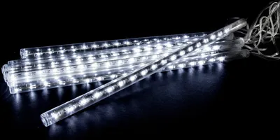 A pile of white LED light tubes on a black background.