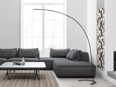 A modern living room with a sectional sofa, coffee table, and a floor lamp.