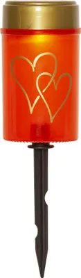 A solar-powered LED candle with a stake for garden use.