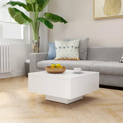 A modern living room scene with a sofa, coffee table, and plant.
