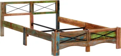 A wooden bed frame with a distressed, multi-colored finish and black metal cross accents.