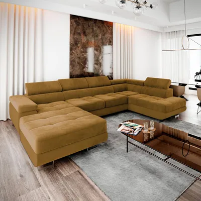 A large, sectional sofa in a modern living room with white curtains and abstract art on the wall.