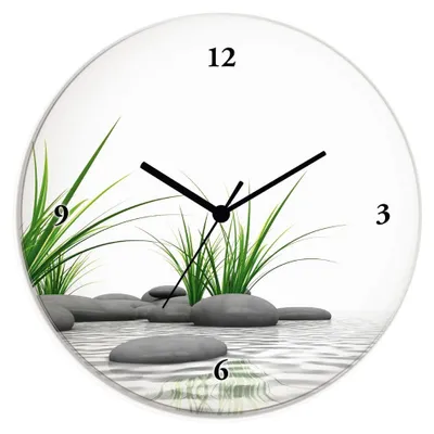 A round wall clock with a Zen garden theme, featuring stones and grass in water.