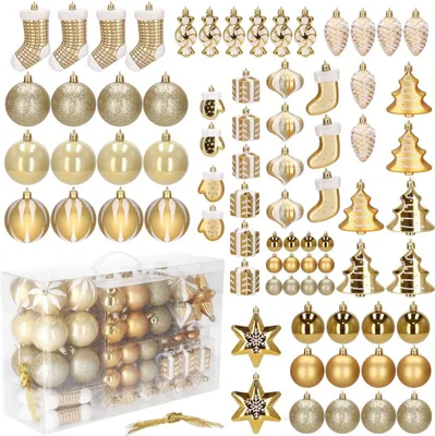 A collection of gold and white Christmas ornaments, including baubles, stockings, pinecones, and trees, arranged in rows and a clear plastic box.