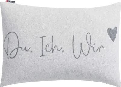A light gray pillow with the text "Du, Ich, Wir" and a heart graphic.