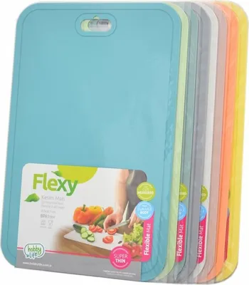 A stack of flexible cutting boards in various colors, with a label showing a person cutting vegetables.