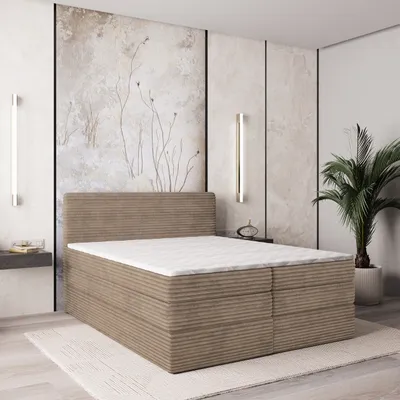 A bedroom scene featuring a bed with a mattress and topper.