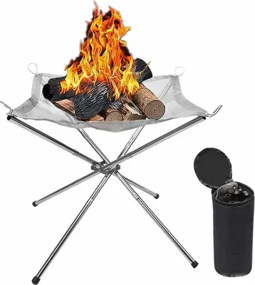 A portable campfire with burning wood on a metal stand, and a storage bag next to it.