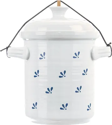 A white ceramic pot with blue floral motifs, suspended by a black string.
