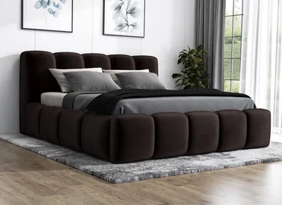 A dark brown upholstered bed with a tufted headboard and frame, set on a gray rug in a bedroom.