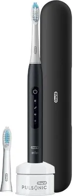 A black electric toothbrush with a charging base, an extra brush head, and a travel case, all set against a white background.