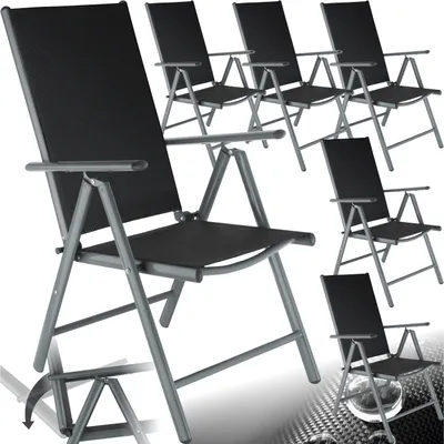 Multiple black folding chairs are arranged in a studio setting against a white background.