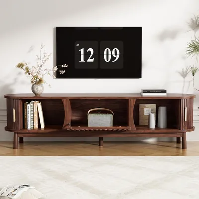 A modern living room with a TV stand and a large TV mounted on the wall.