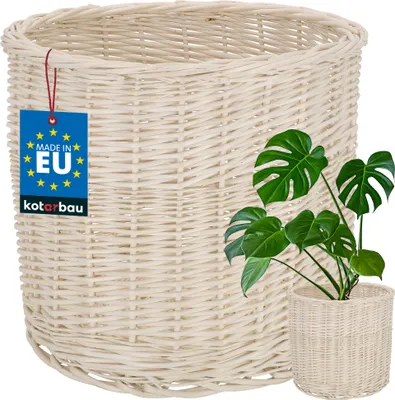 A white wicker basket with a plant inside and a tag indicating it is made in the EU.