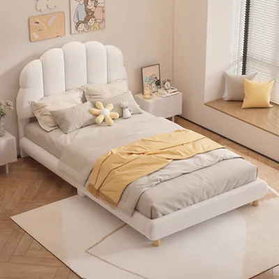 A bedroom scene with a white bed and bedding.
