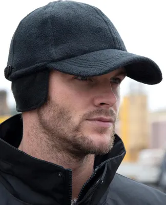 A man wearing a black fleece cap with ear flaps.