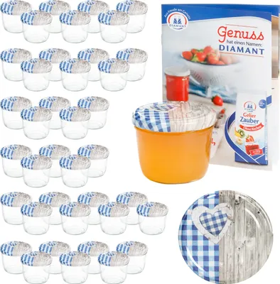 A collection of glass jars with lids, a jar filled with orange jam, and a decorative plate.