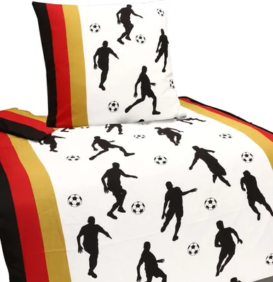 A bedding set with a soccer theme, featuring black silhouettes of soccer players and soccer balls on a white background. The bedding also has stripes in black, red, and gold, resembling the German flag.