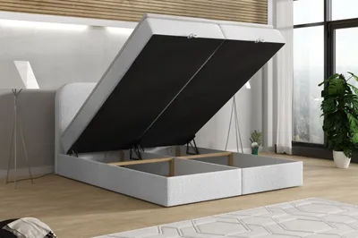 A bed with its storage compartment open, showing the interior space.