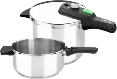 A stainless steel pressure cooker with a separate pot in front of it, on a white background.