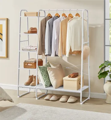 A white metal garment rack with clothes, shoes, and accessories displayed on shelves and hanging on the rack.