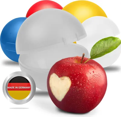 A red apple with a heart carved into it, surrounded by colorful plastic containers and a 'Made in Germany' badge.