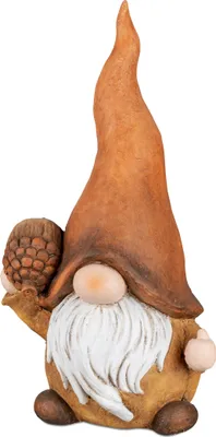 A ceramic gnome figurine with a tall, pointed hat and a white beard, holding an acorn.