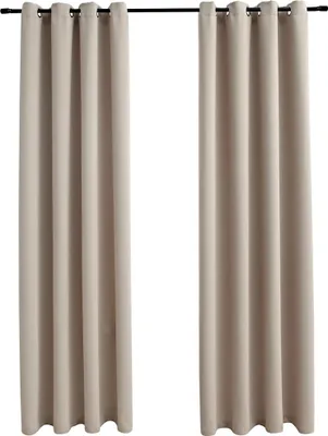 Two beige curtains hanging from a curtain rod.