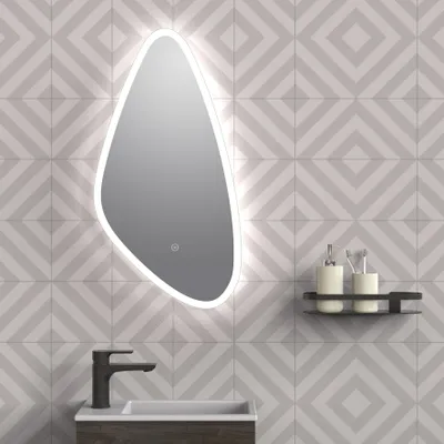 A modern bathroom vanity with a sink, faucet, and an illuminated mirror mounted on a patterned tile wall.