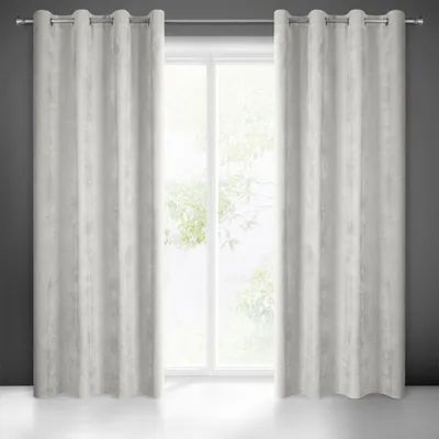 Two beige curtains hanging in front of a window.
