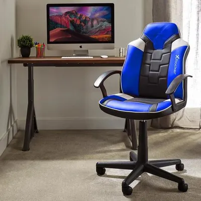 A gaming chair and desk setup in a room.