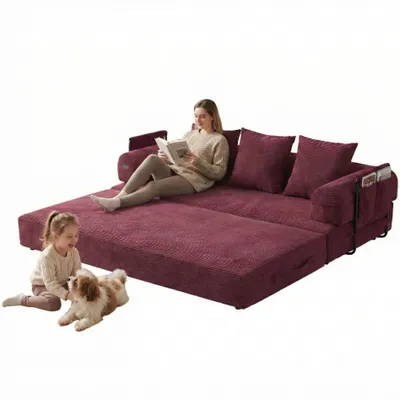 A woman reads a book on a sofa while a child and dog are on the floor next to it.