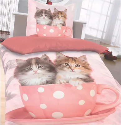 A bedding set with a kitten motif, featuring two kittens in a teacup.