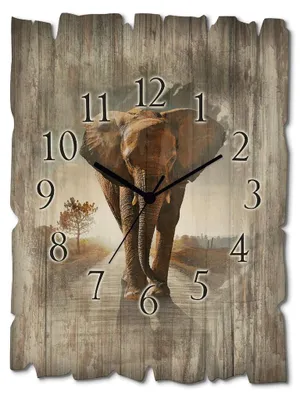 A clock with an elephant image on a wooden background.