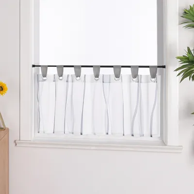 A close-up view of a window with sheer curtains.