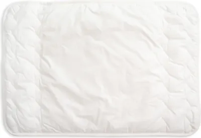 A white quilted baby pillow lies flat on a white background.