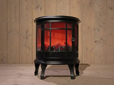 A black electric fireplace with a faux flame effect is shown in front of a wooden wall.