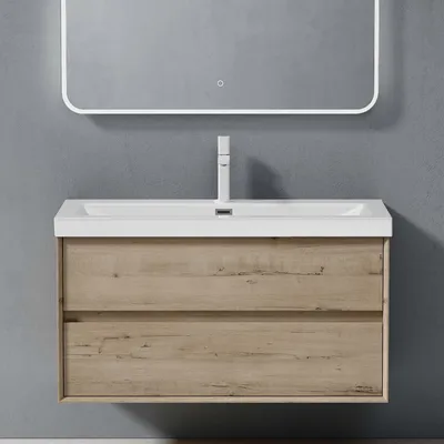 A modern wall-mounted bathroom vanity with a sink and faucet, against a grey wall.