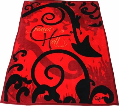 A red fleece blanket with black abstract designs and text.