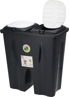 A black dual-compartment trash bin with white lids, shown from the front.