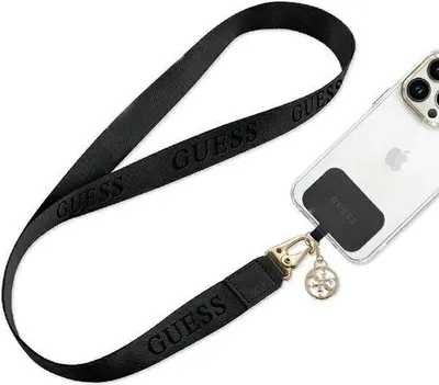 A black crossbody strap with the Guess logo is attached to a clear phone case on a white background.