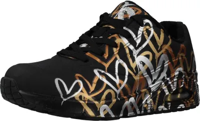 A single black sneaker with a metallic heart pattern is shown against a white background.