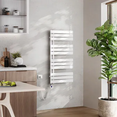 A modern bathroom or kitchen setting with a white towel warmer mounted on a light gray wall.