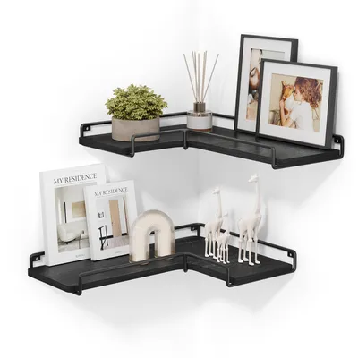 A set of two black L-shaped corner shelves mounted on a white wall, decorated with various items.