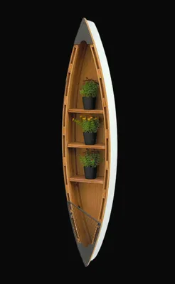 A wooden shelf shaped like a canoe, mounted on a black background.