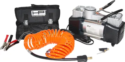 A portable air compressor kit with accessories laid out on a white background.