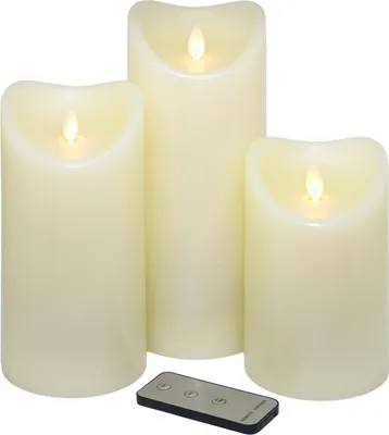 Three LED candles of varying heights are arranged on a white background, with a remote control in the foreground.