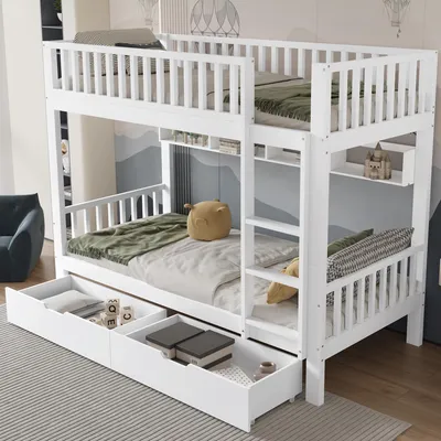 A white wooden bunk bed with drawers underneath, set up in a child's room with decorative wall art.