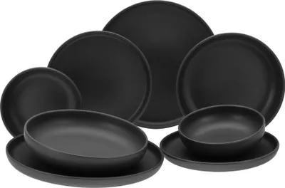A collection of black ceramic plates and bowls are arranged on a white background.