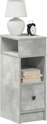 A tall, narrow nightstand with a concrete-like finish, featuring an open shelf, a drawer, and a small shelf above the drawer. A white lamp and a black alarm clock are placed on the top surface.